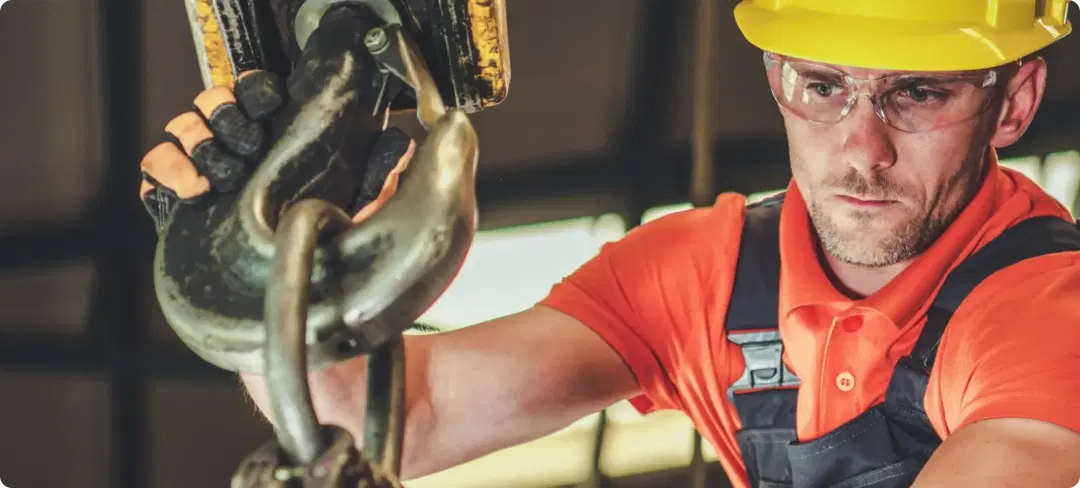 worker inspecting lifting equipment